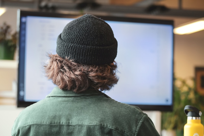 control mental, person in green shirt wearing black knit cap