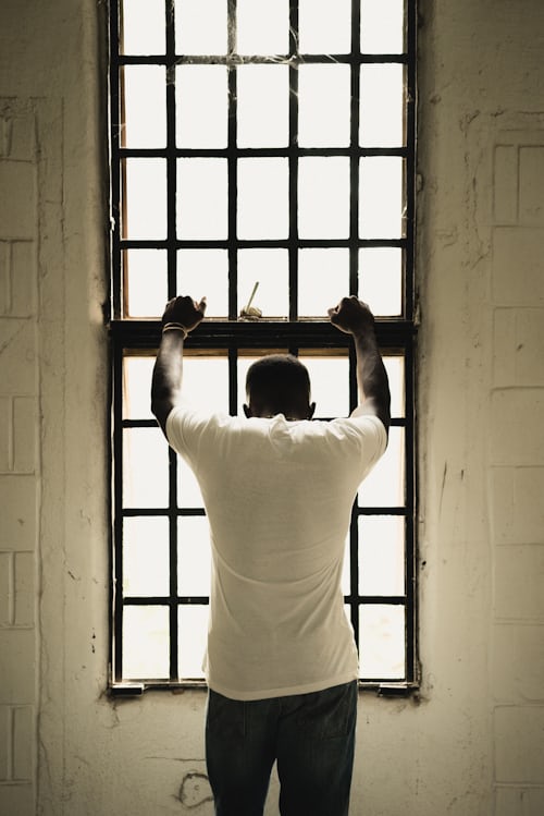 Picture of man in jail cell, like the risk of getting banned from Instagram