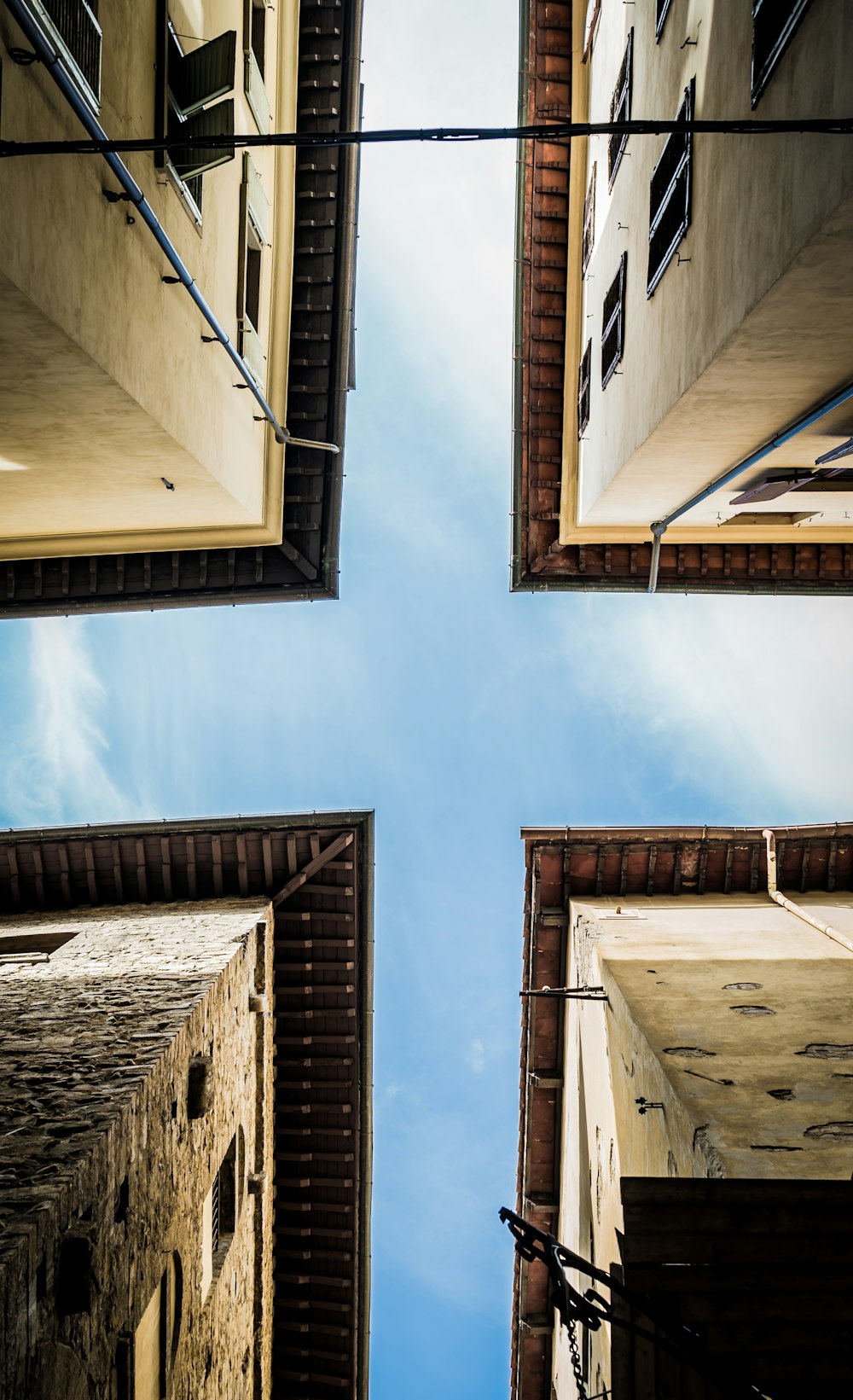 low angle photography of brown concrete building under blue sky during daytime