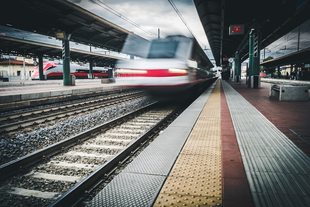 red and white train on rail way during daytime