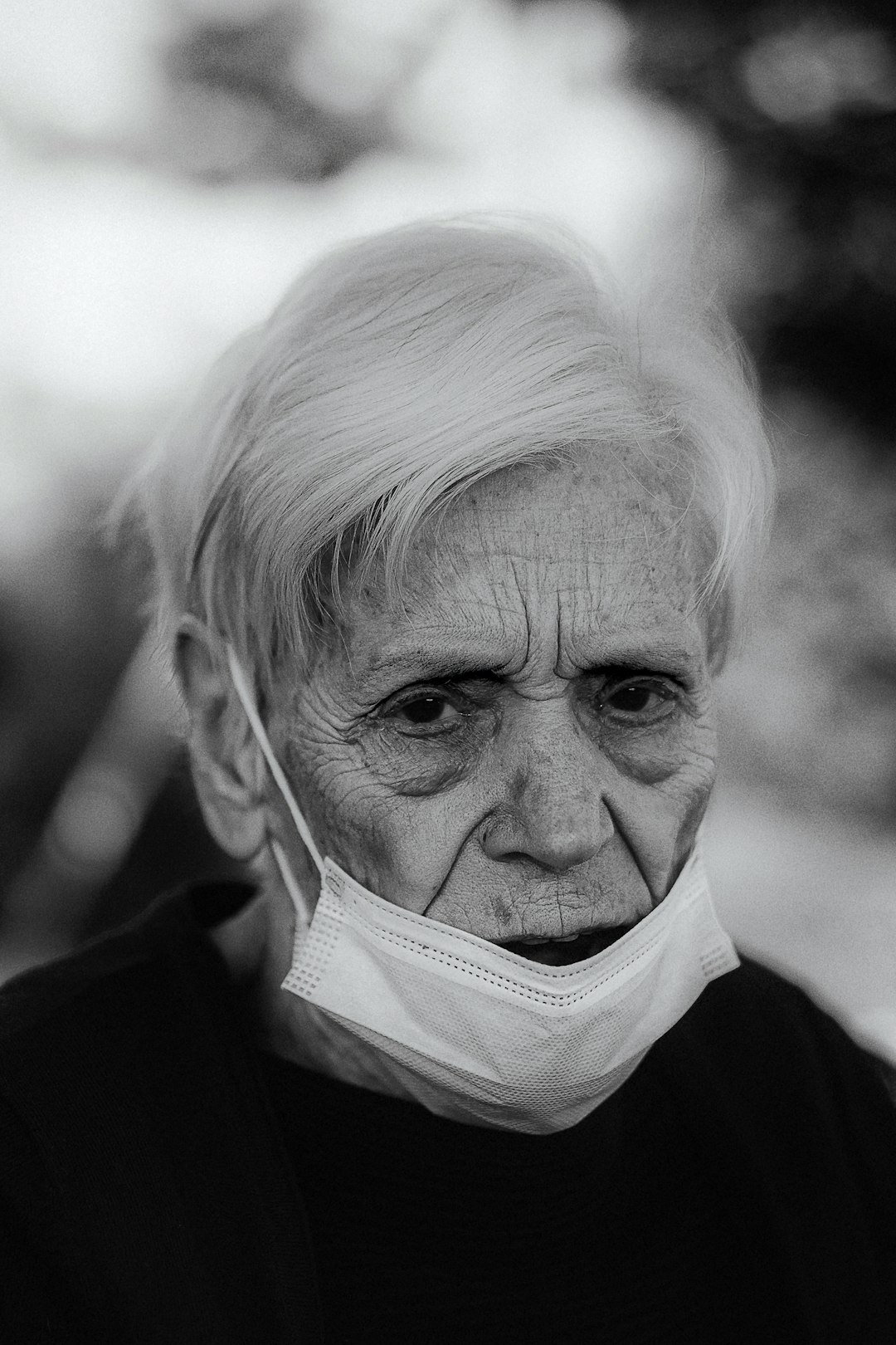 man in white scarf and black coat