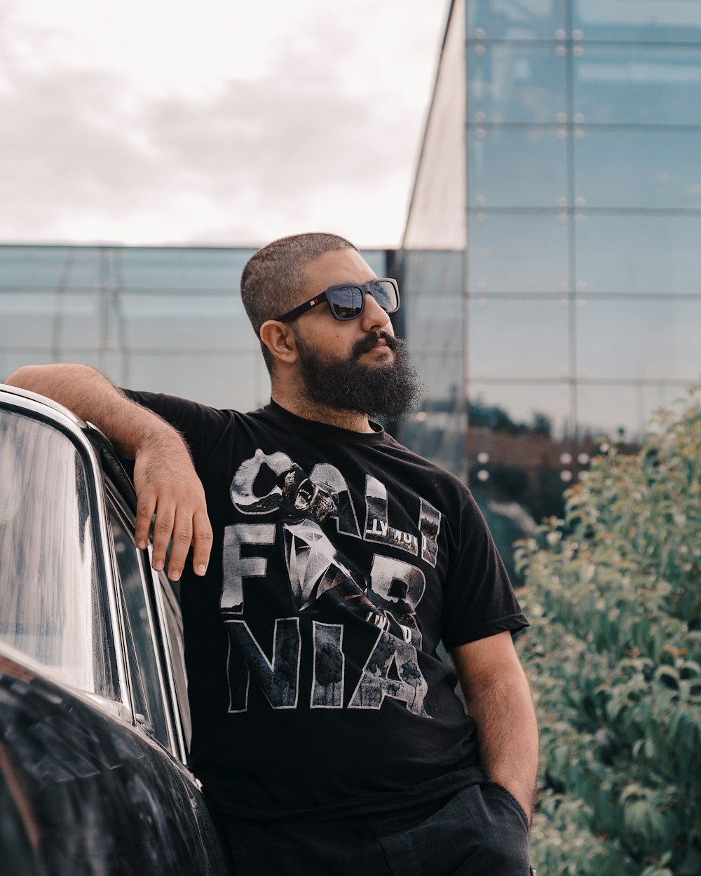 man in black crew neck t-shirt wearing black sunglasses