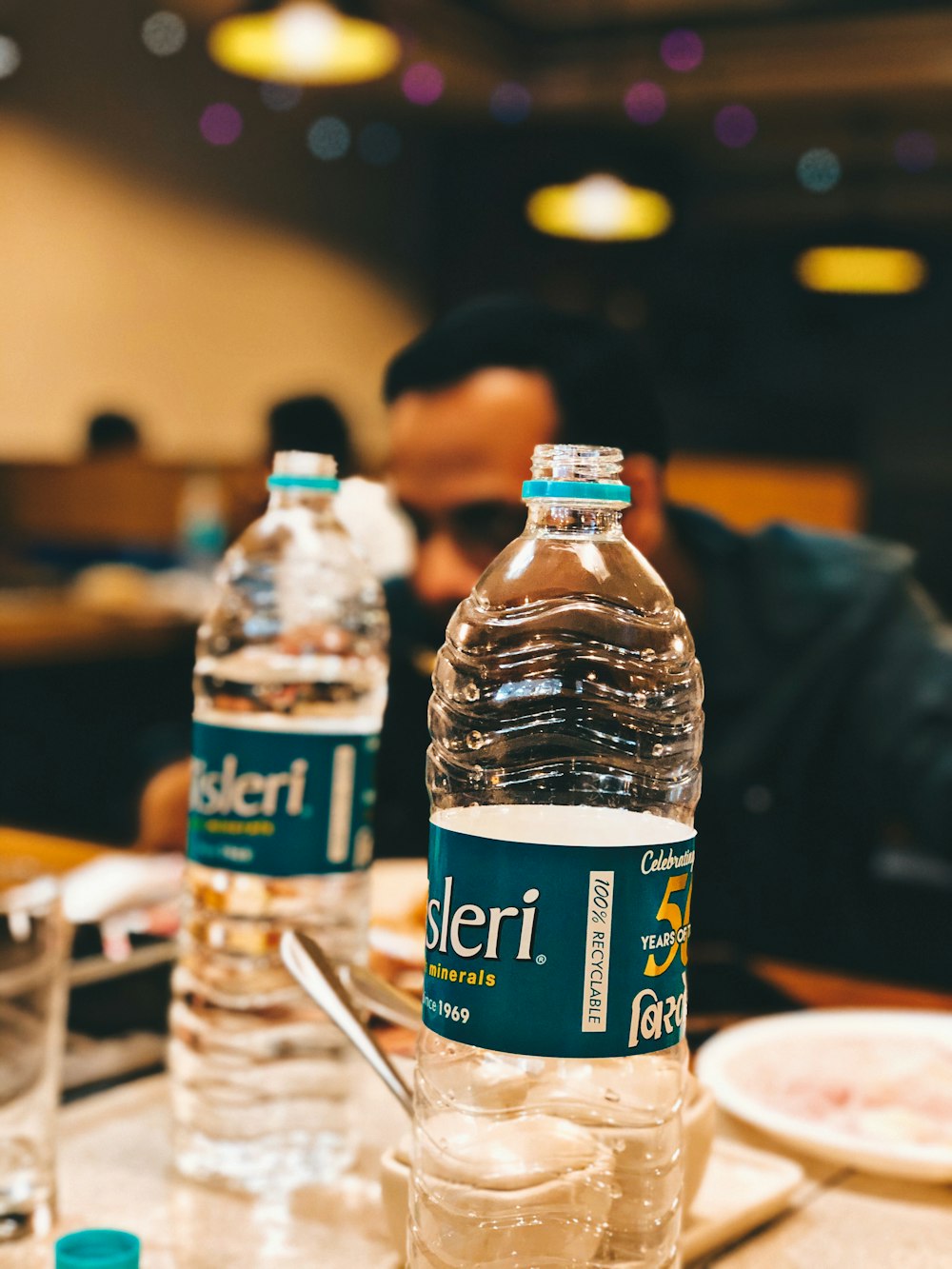 blue labeled plastic bottle on table