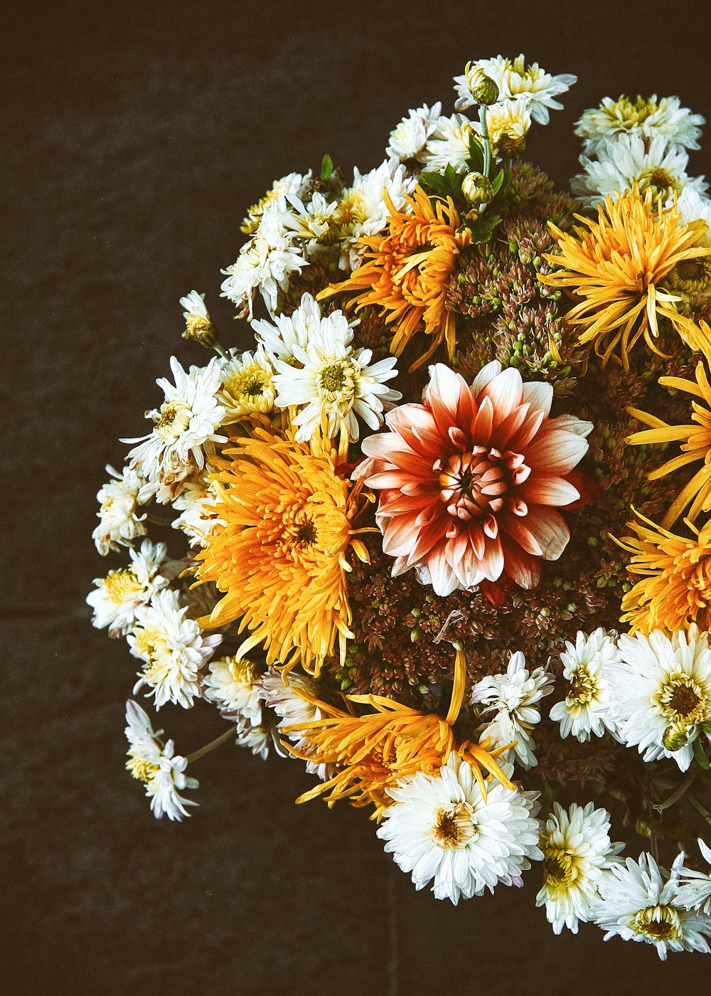 white and yellow flowers on black textile