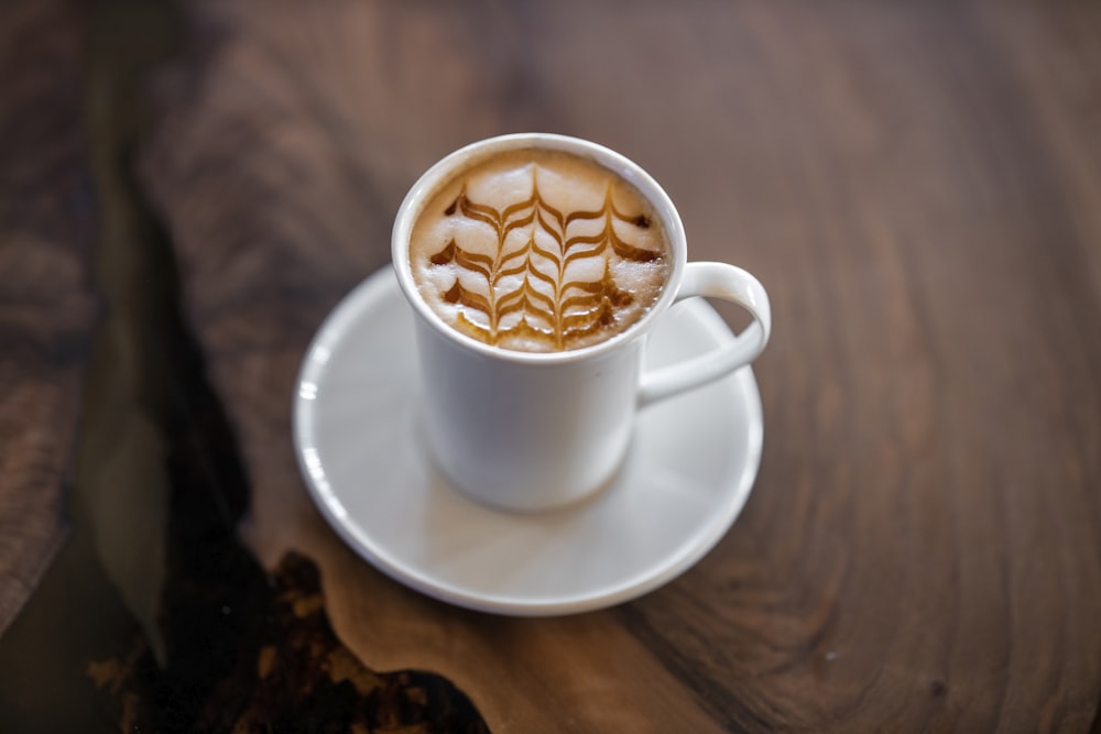 white ceramic mug on white ceramic saucer