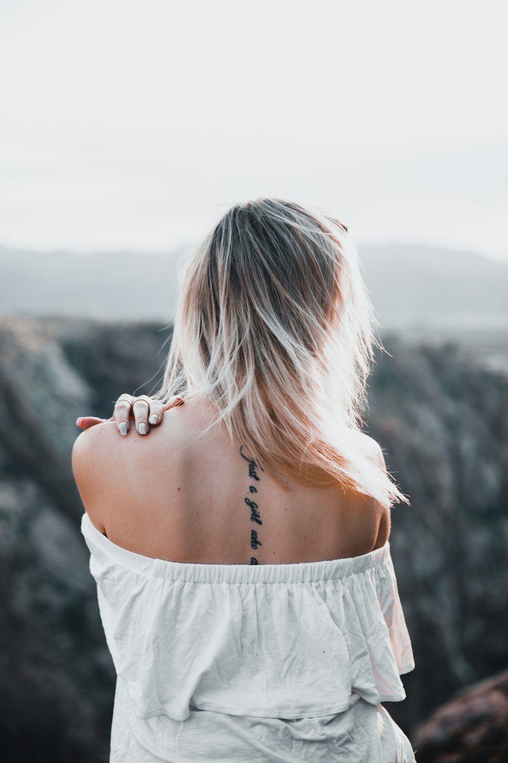 a woman with a tattoo on her back