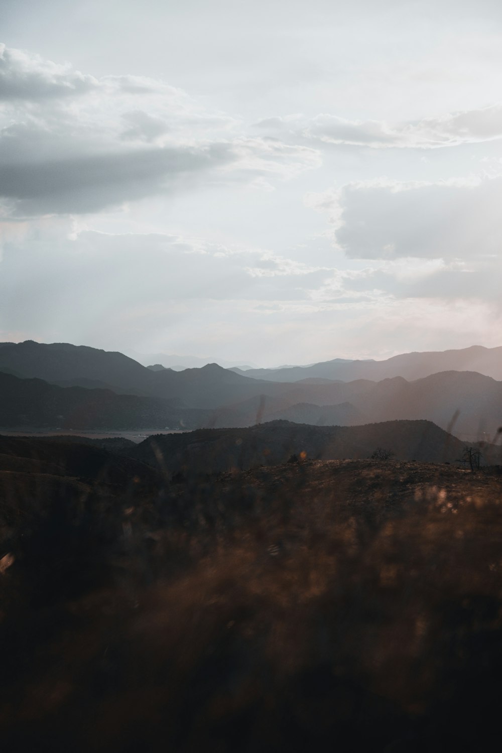 silhouette of mountains under cloudy sky during daytime