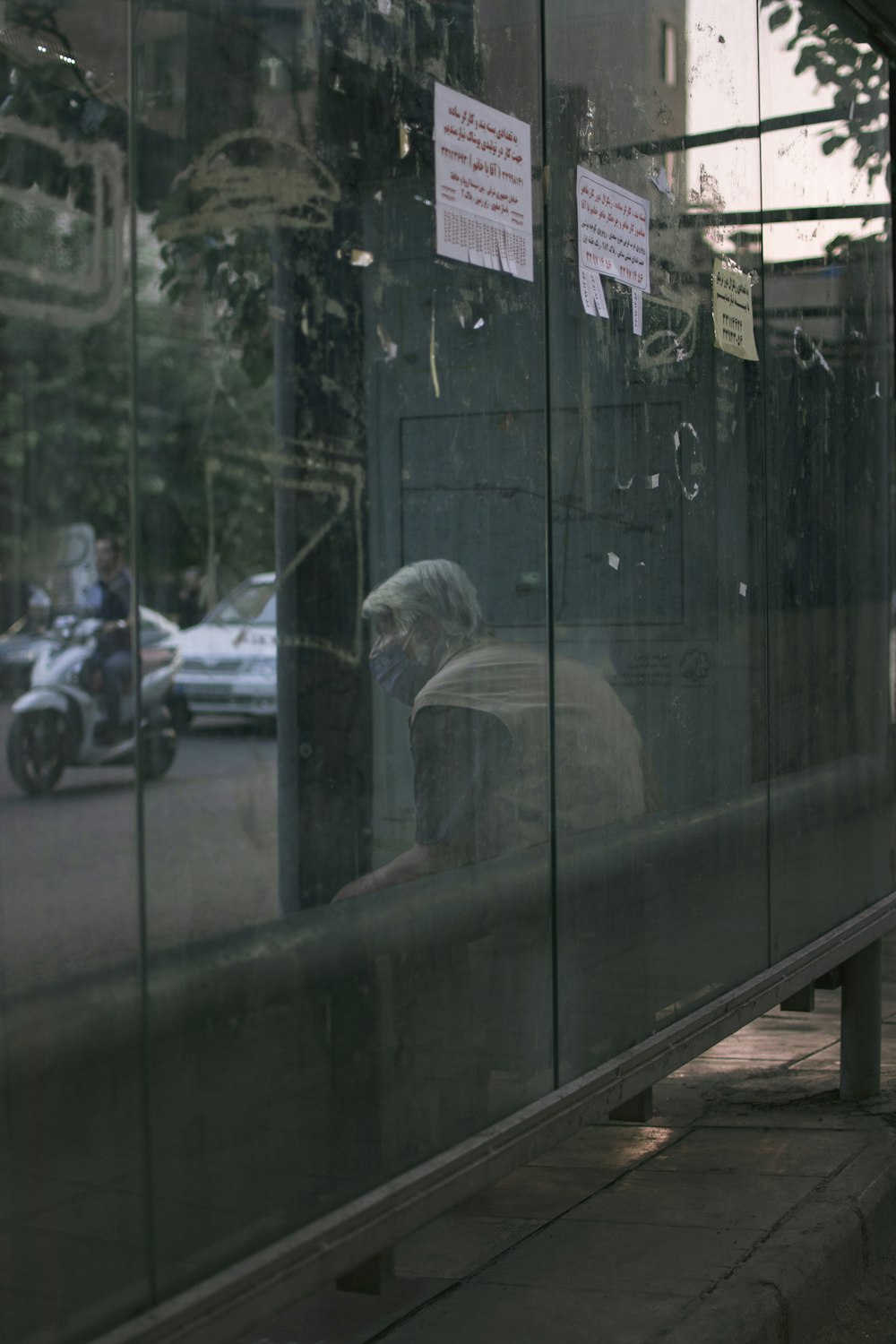 white car parked beside green glass wall