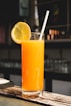 orange juice in clear drinking glass