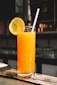 orange juice in clear drinking glass