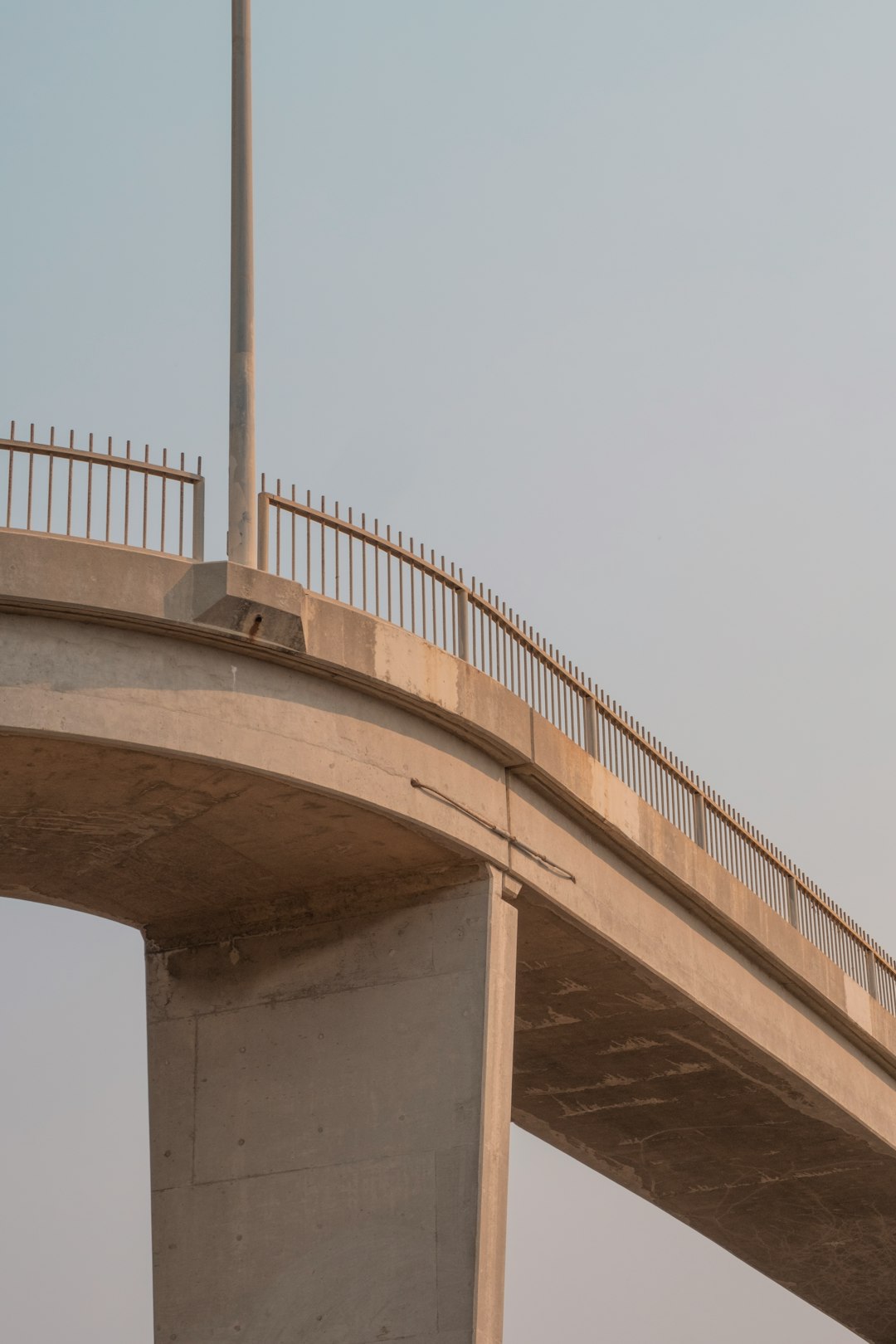 brown concrete bridge under white sky during daytime