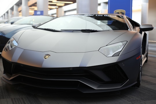 black lamborghini aventador parked in front of building