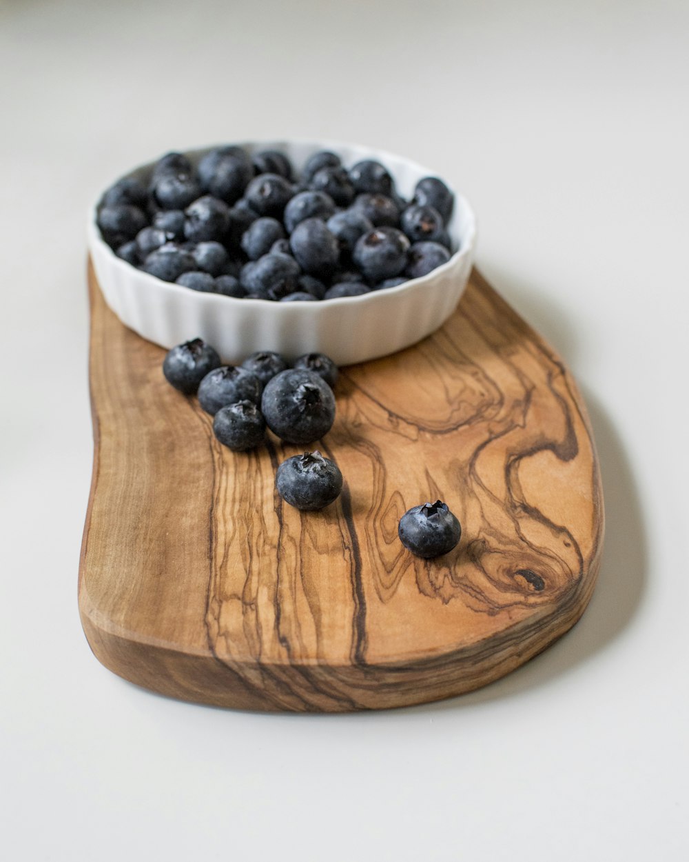 black berries on brown wooden bowl