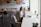 A photo of customer Jamie, sitting in a modern office space, looking pleased.