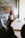Close-up of a customer using a smartphone in a modern office environment.