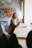 Close-up of a customer using a smartphone in a modern office environment.