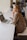woman in brown coat using macbook air