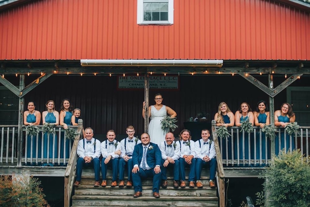 group of people standing on black wooden stairs