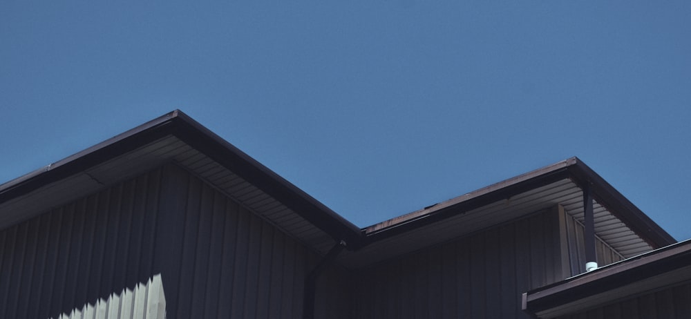 blue sky over brown wooden house