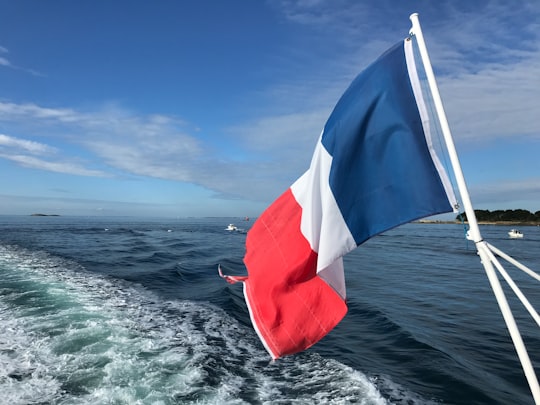 red white and blue flag on boat during daytime in Océan Atlantique France