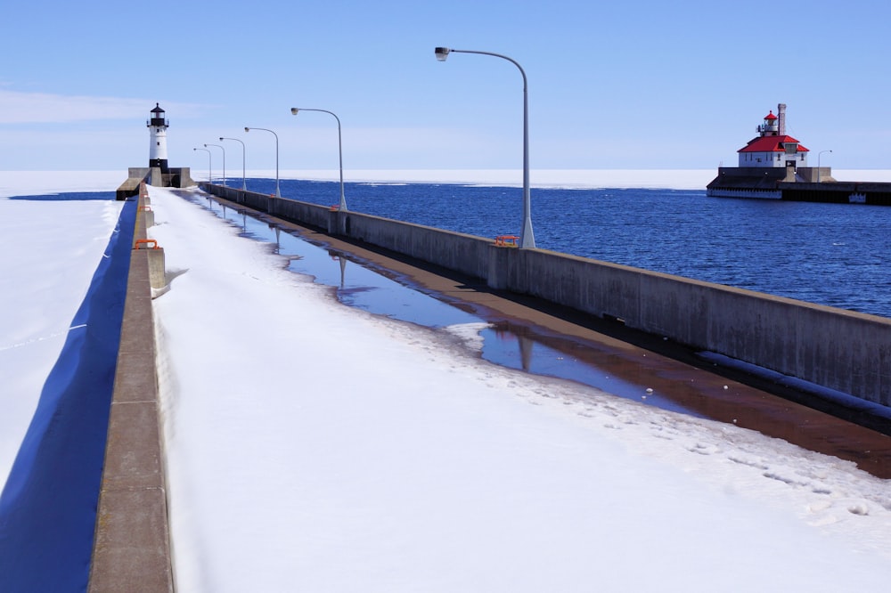 gray concrete bridge over body of water during daytime