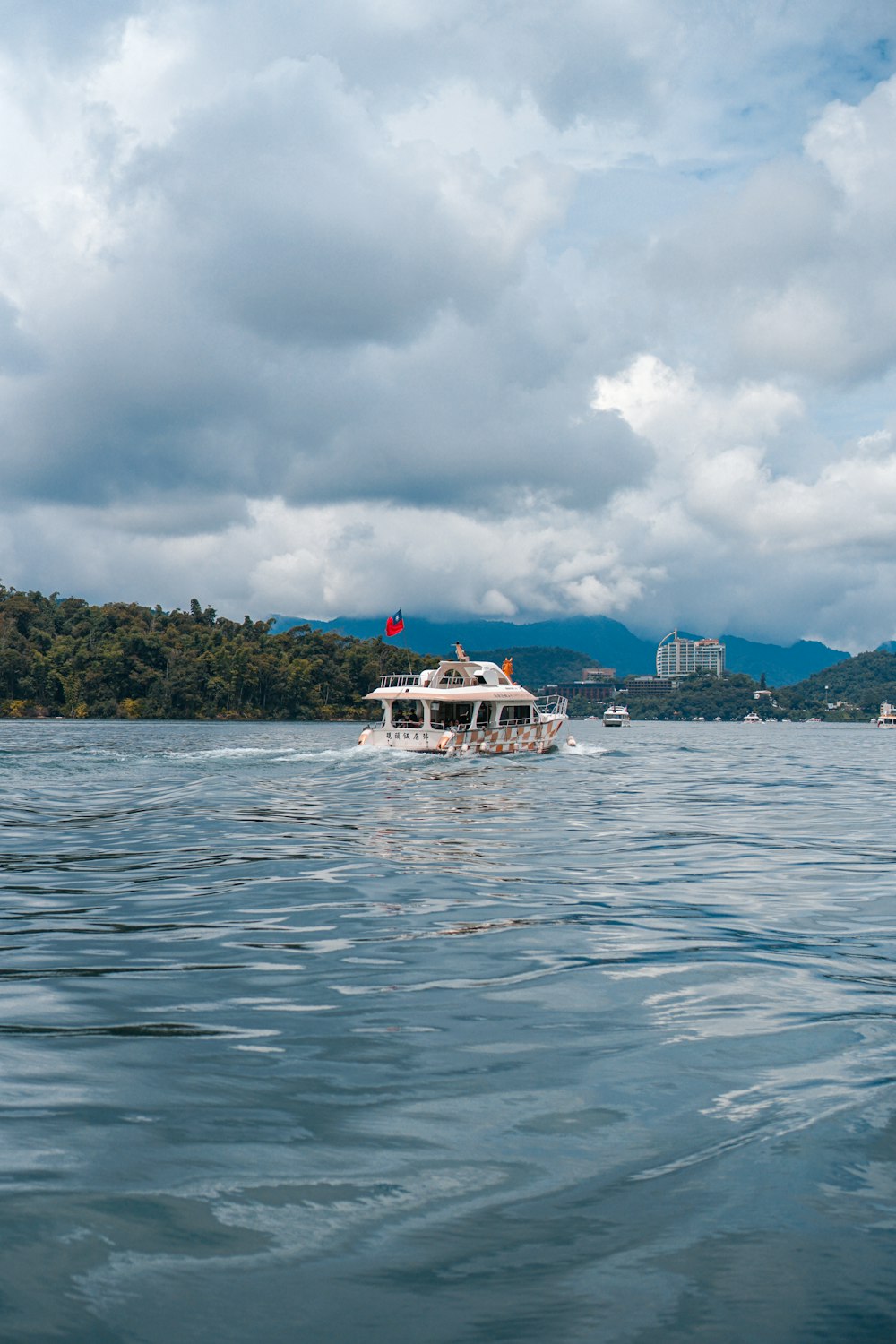 white boat on sea under cloudy sky during daytime