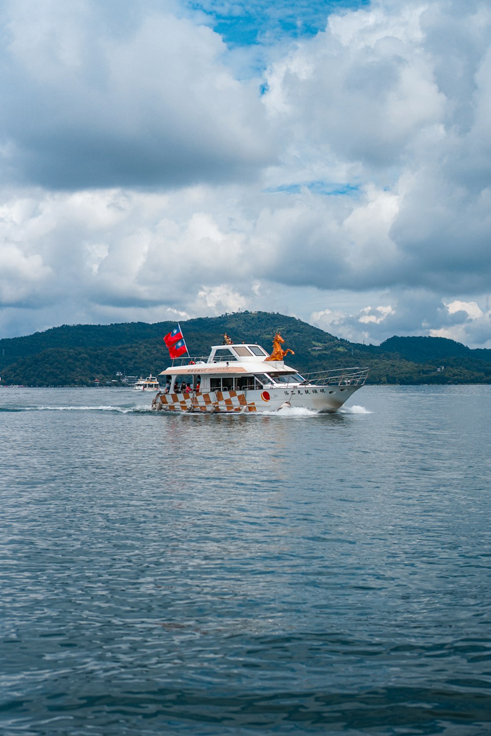 white boat on sea under cloudy sky during daytime