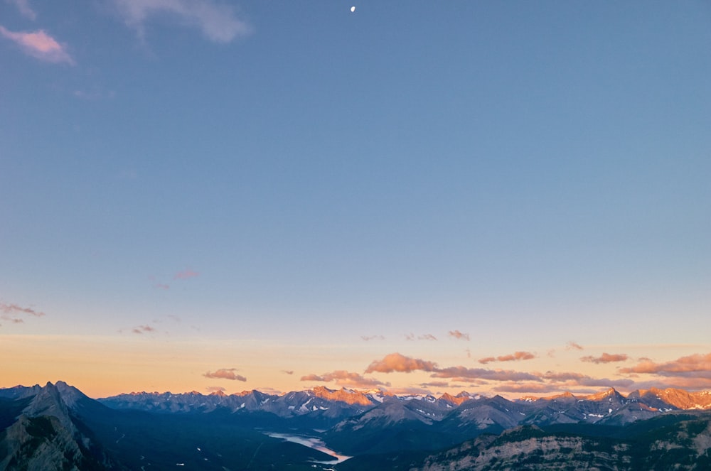 snow covered mountains under blue sky during daytime