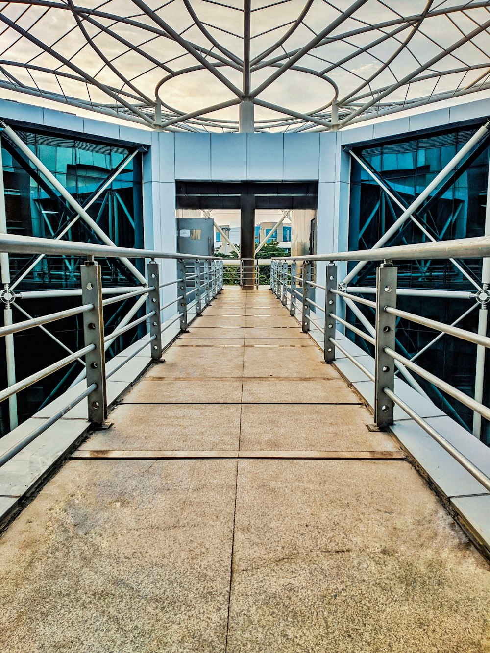 brown concrete pathway with stainless steel railings