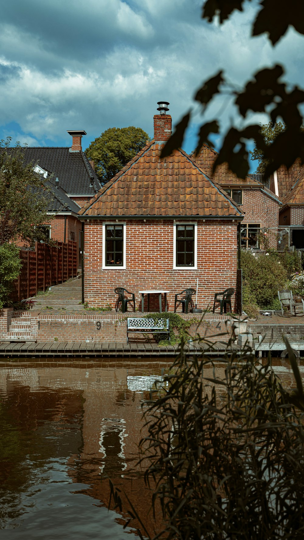 brown brick building beside river during daytime