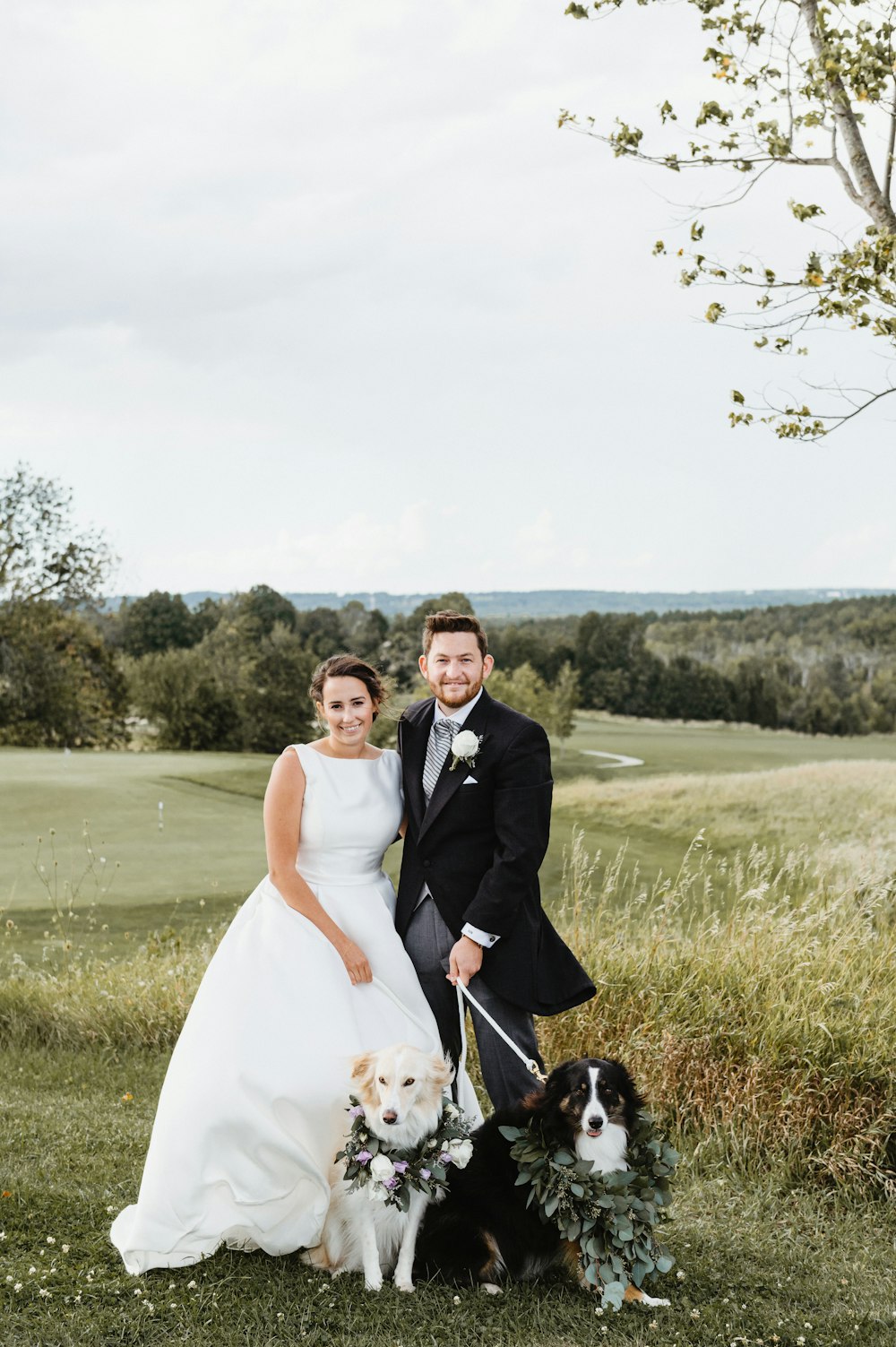 man and woman in white dress walking on green grass field during daytime