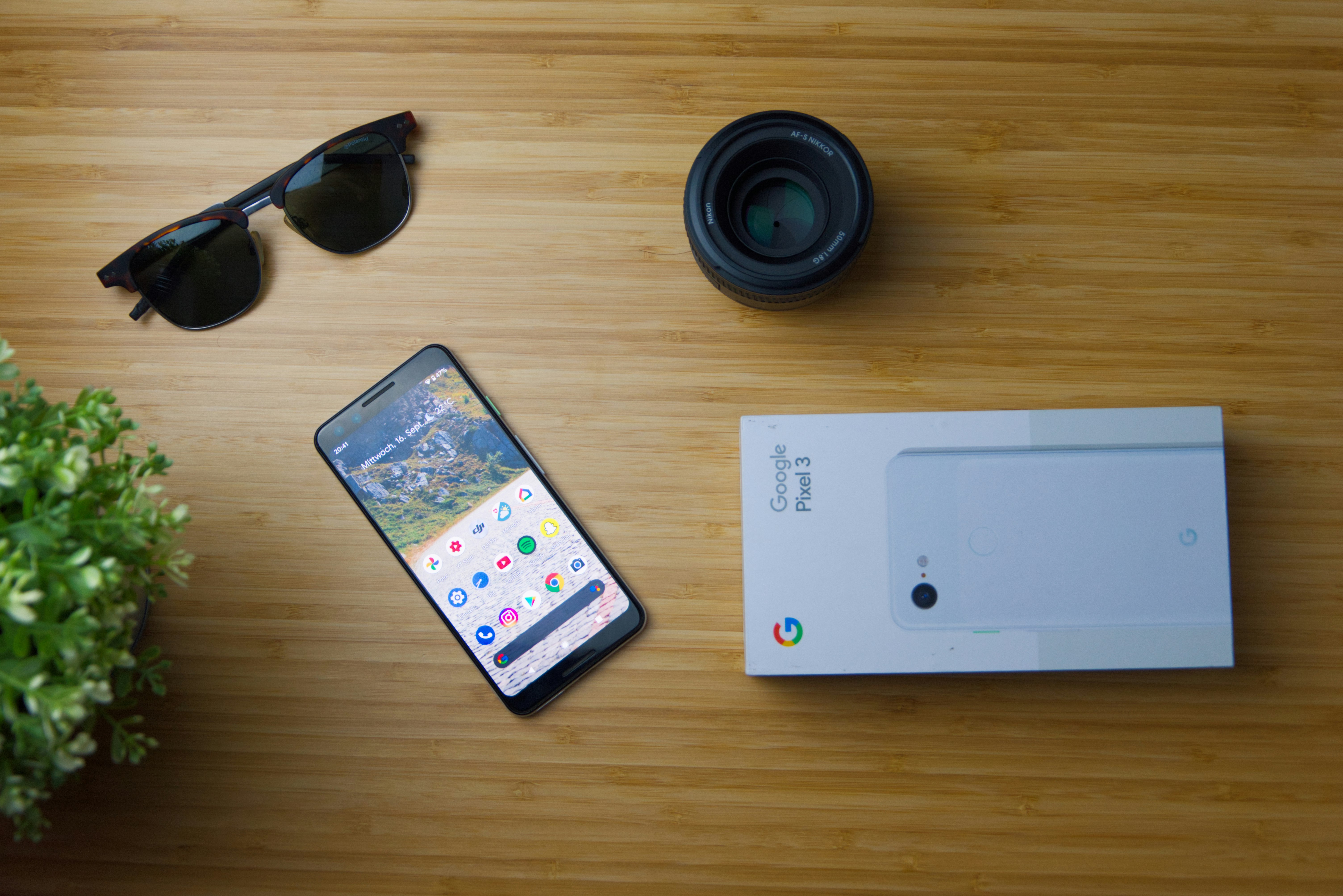 white iphone 5 c beside black sunglasses