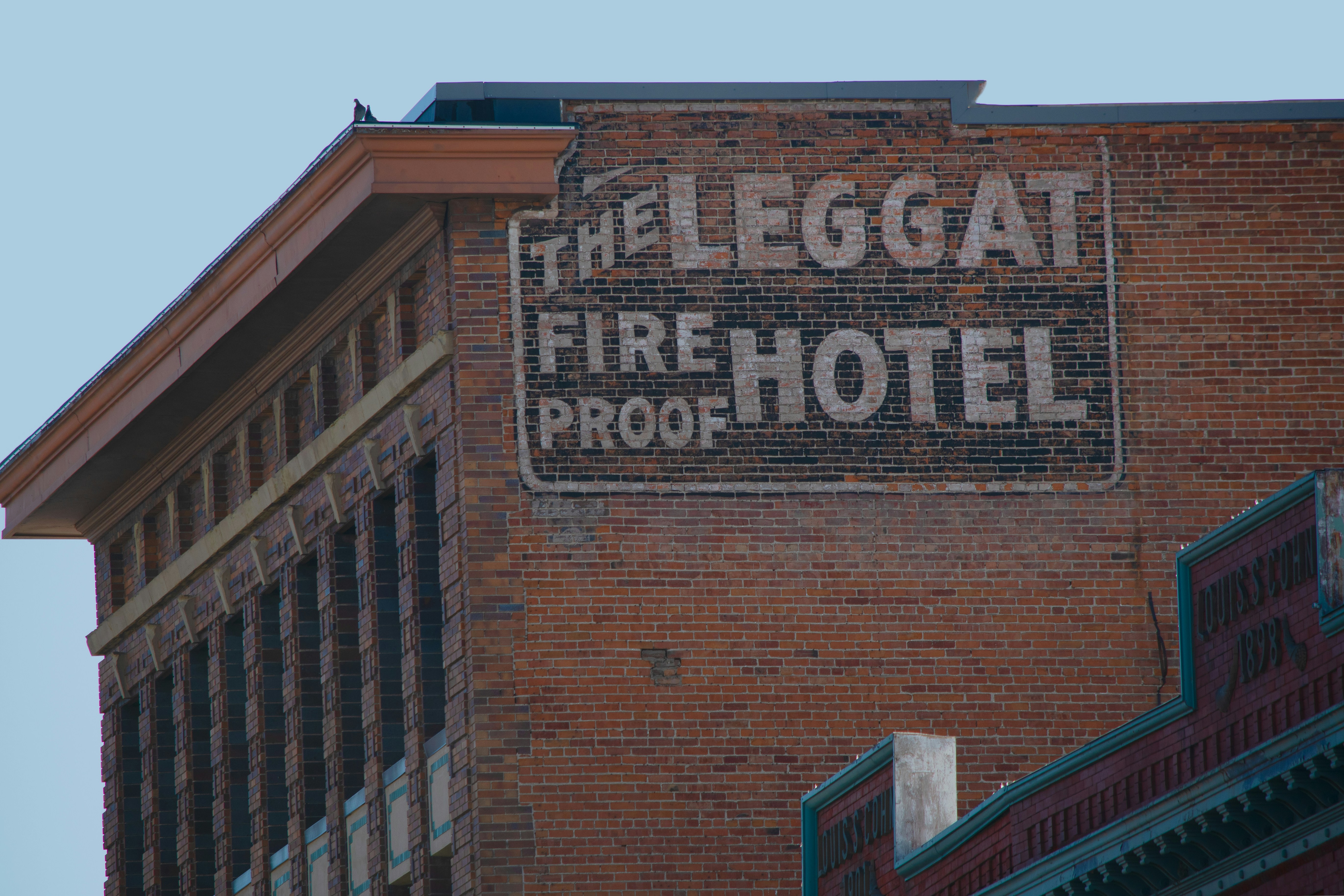 brown brick building with blue and white signage, 