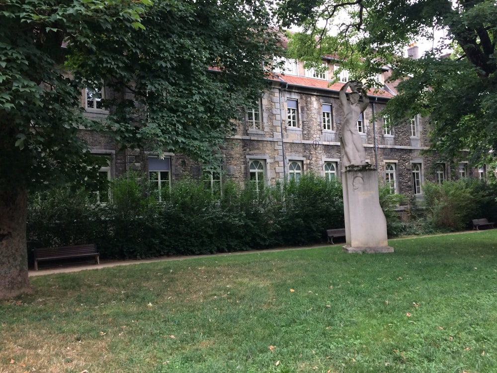 green grass field near brown concrete building during daytime