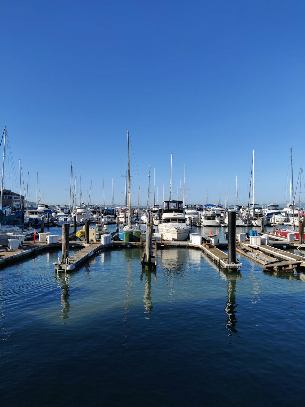 white and blue boat on dock during daytime