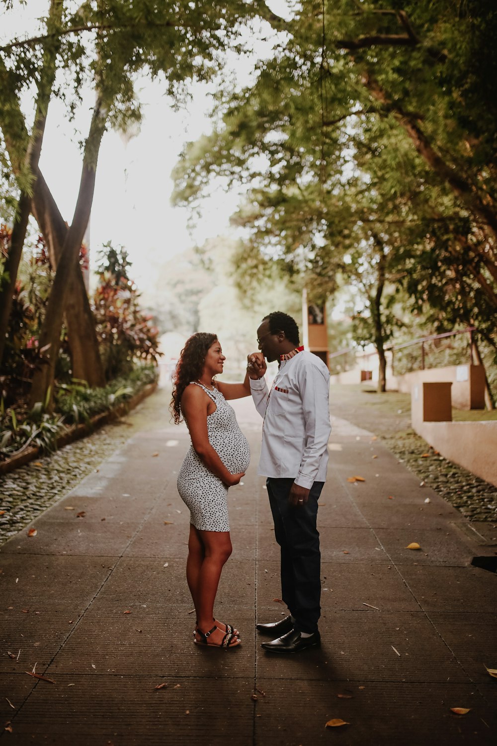 man and woman kissing on the street during daytime