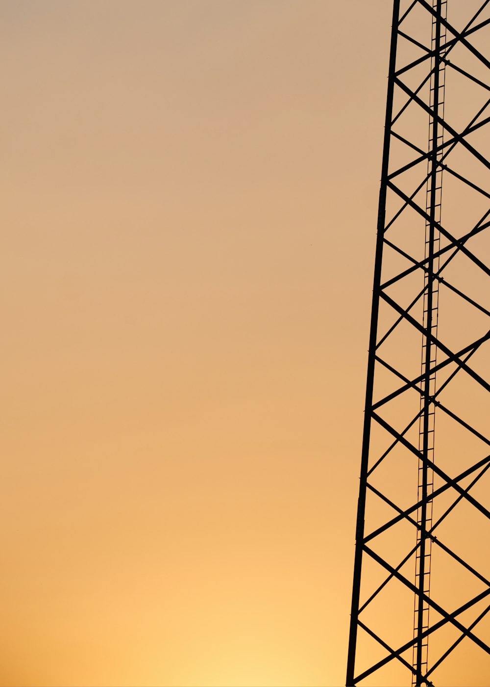 black metal tower under orange sky