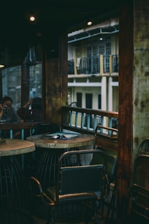 A rustic wooden table with industrial-style chairs in a cozy setting.