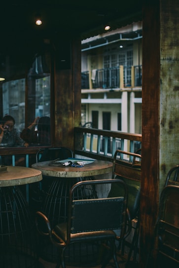 A rustic wooden table with industrial-style chairs in a cozy setting.