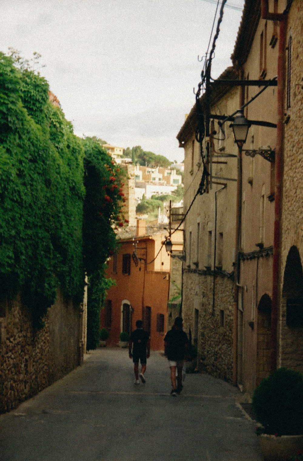 people walking on street between buildings during daytime