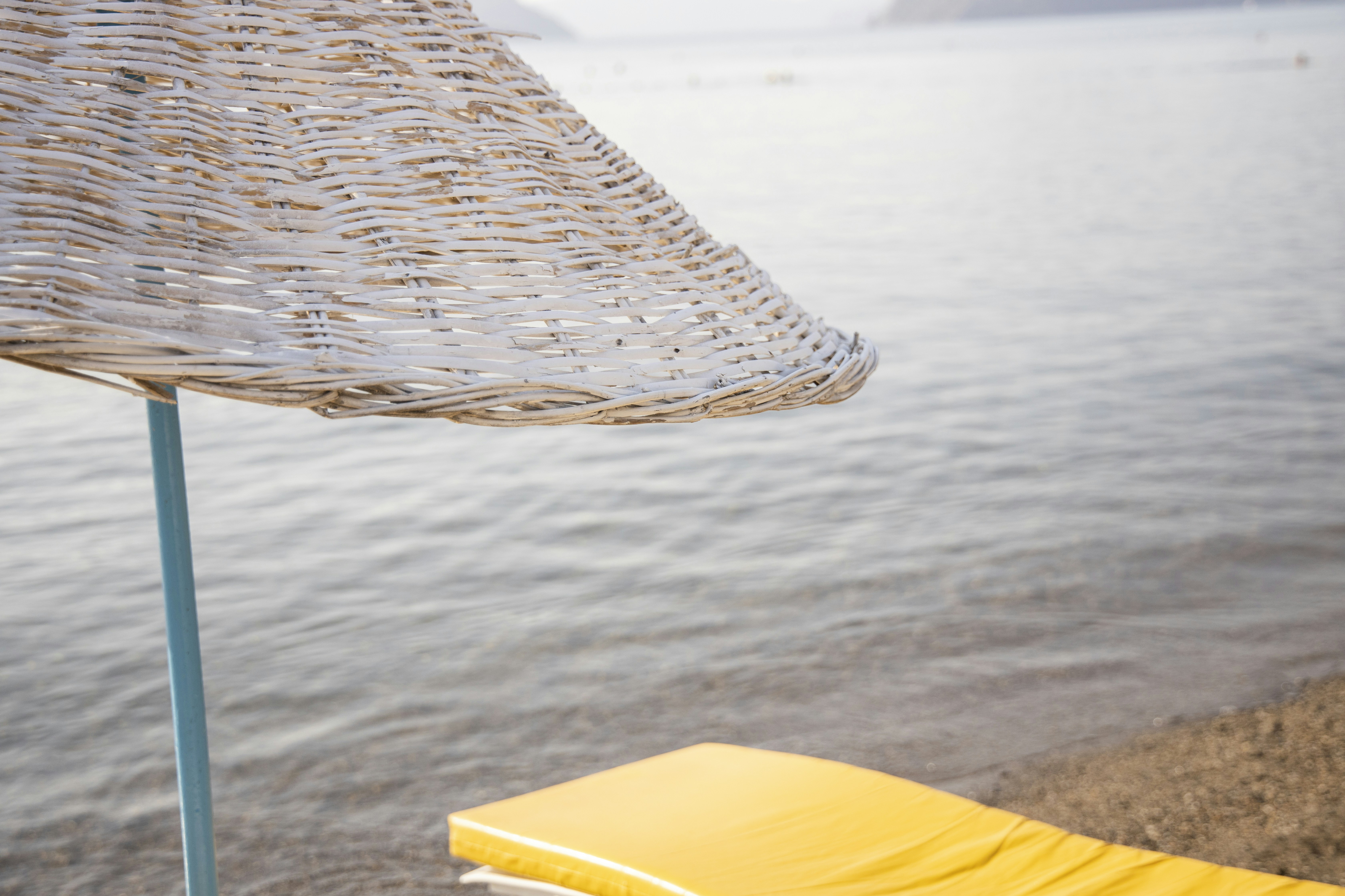 beach umbrella, lounge chair and sea background