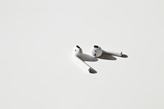 A sleek pair of maivoz wireless earbuds displayed on a minimalist background.