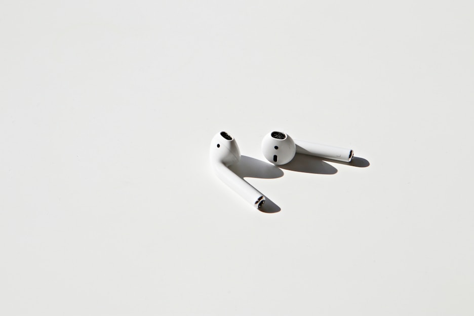 A sleek pair of maivoz wireless earbuds displayed on a minimalist background.
