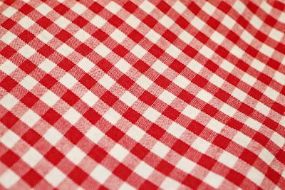 red and white checkered textile tablecloth teams background