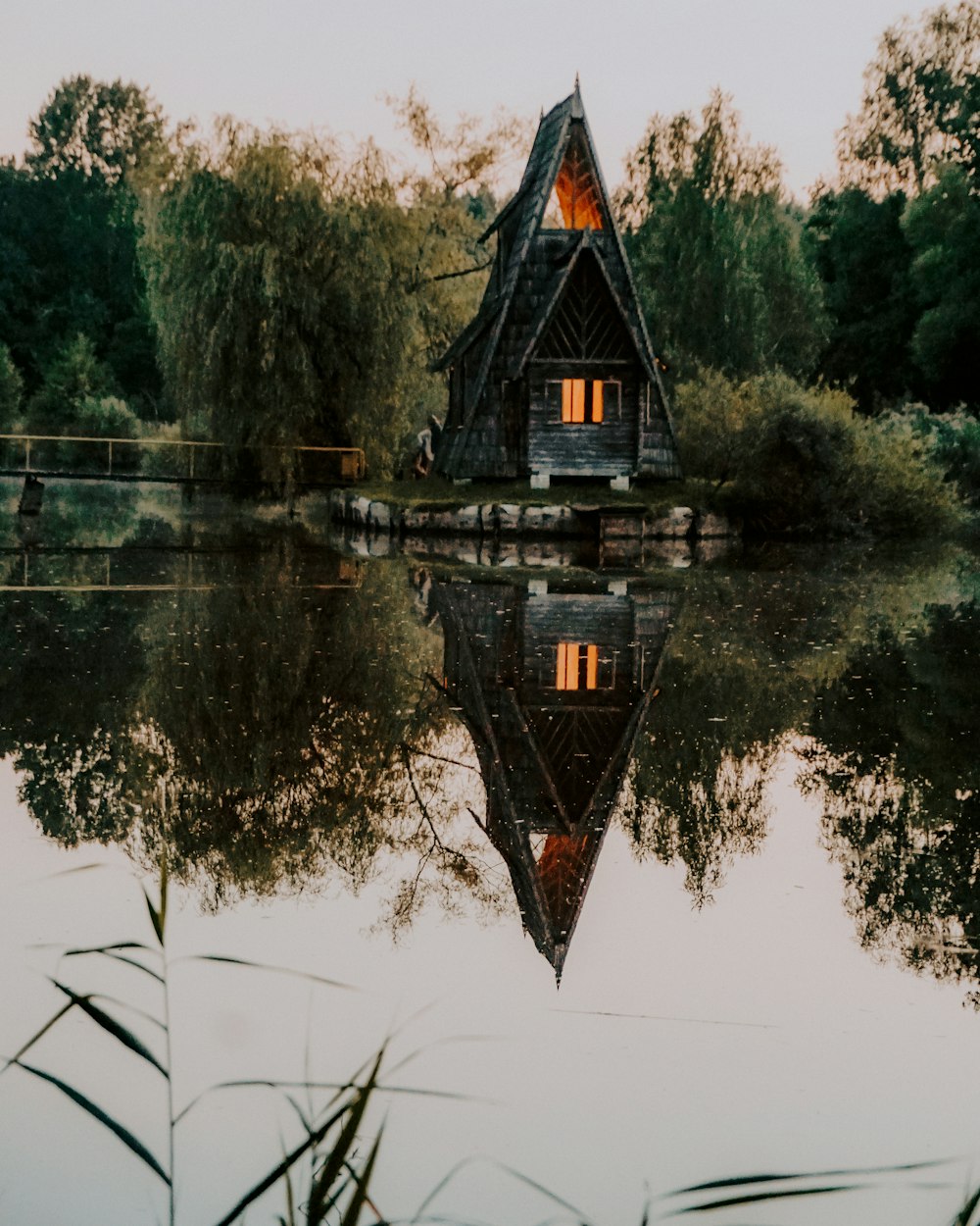 brown and black house on lake during daytime