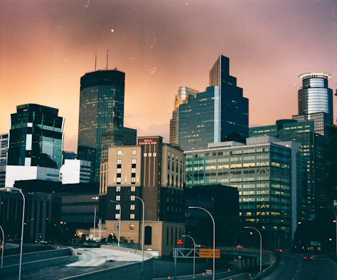 cars on road near high rise buildings during daytime