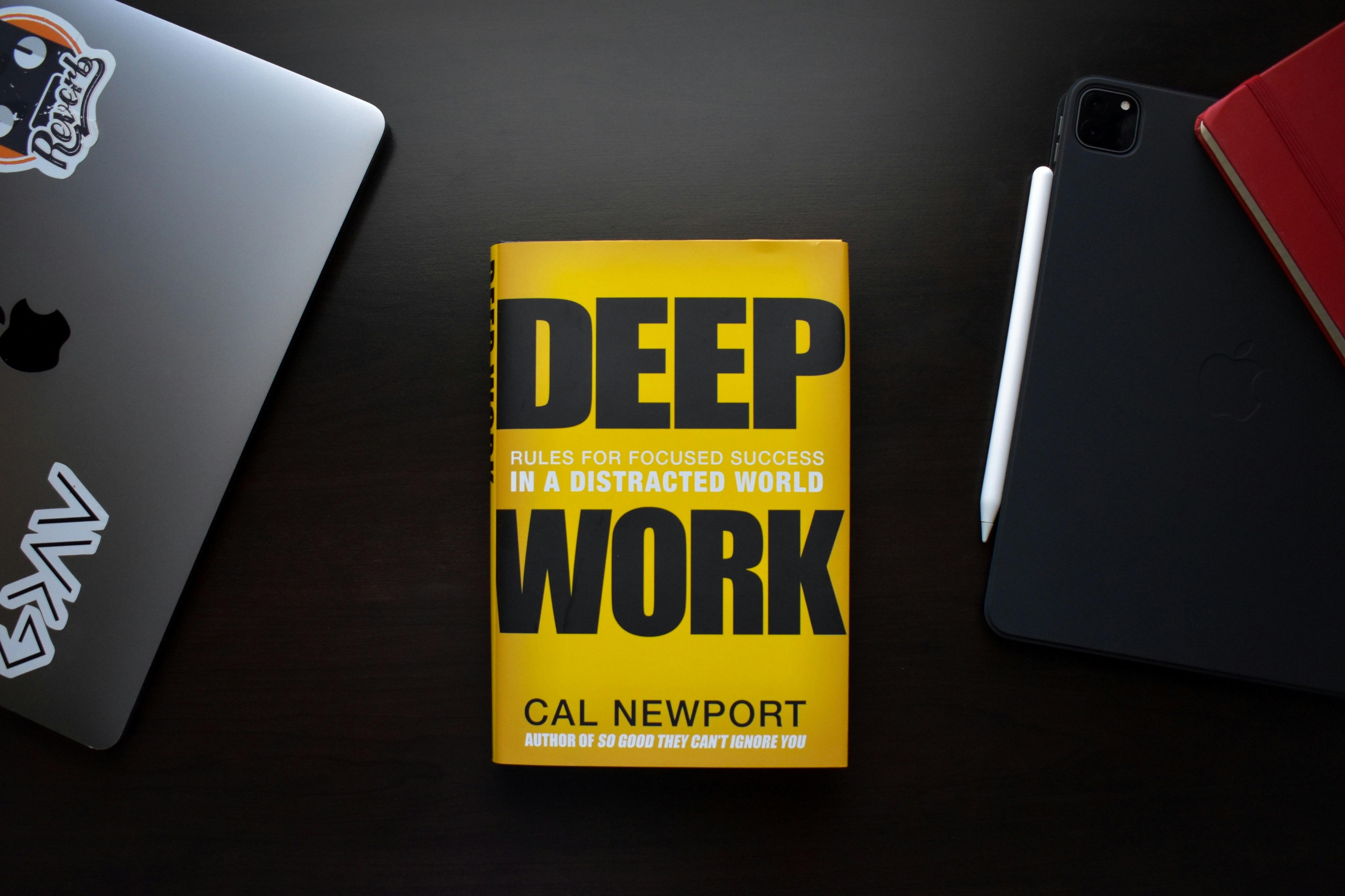 Deep Work book cover showing focused solitary figure at desk in dark room