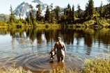 woman in black tank top and white shorts standing on river during daytime