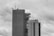 A tall, concrete building with several antennas and satellite dishes on the rooftop. The structure appears industrial and modern, with vertical lines and a utilitarian design. The sky is overcast, adding a gray tone to the scene.