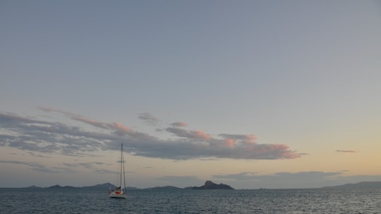 boat on sea under cloudy sky during daytime in Whitsundays QLD Australia